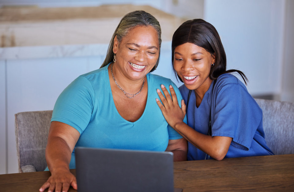 two woman looking at the laptop