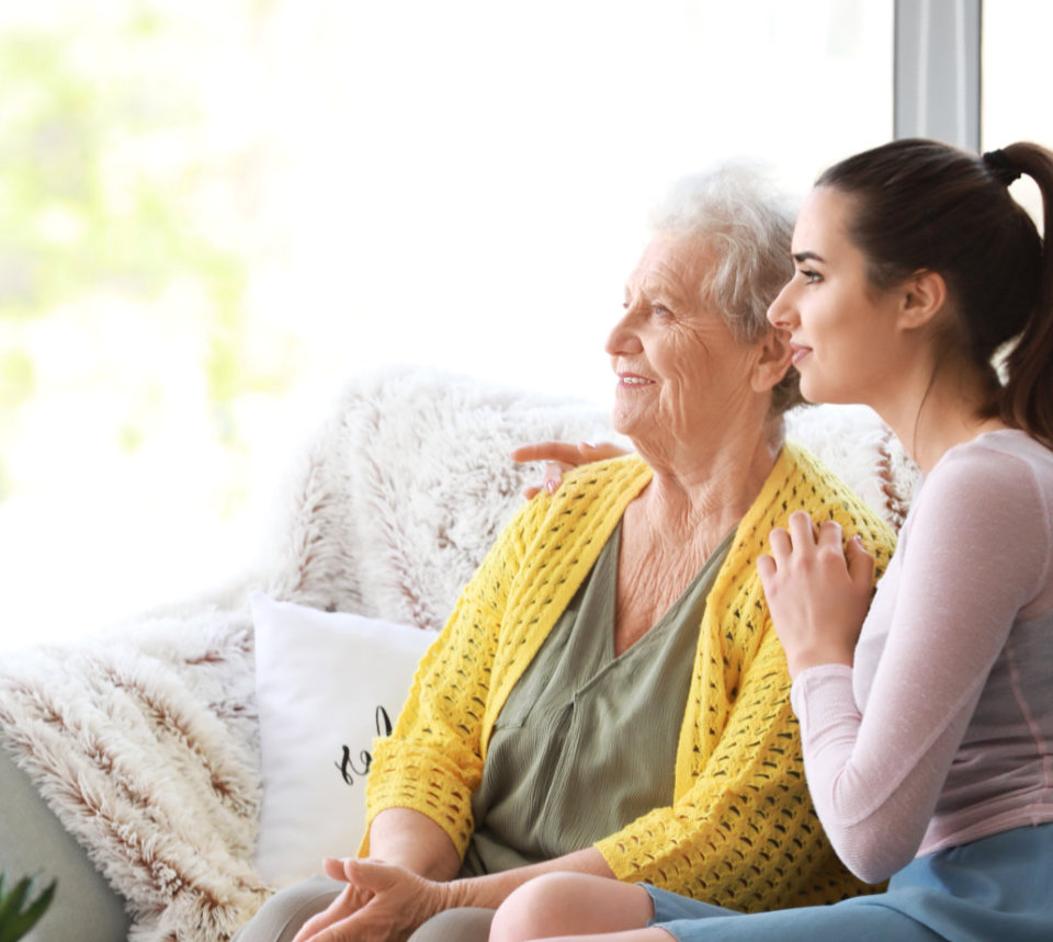 lady holding elderly shoulders