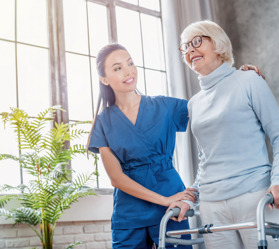 lady helping elderly to walk