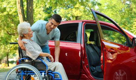 man helping grandma on the wheelchair