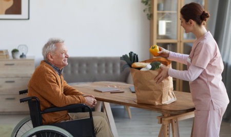 aide bringing a grocery