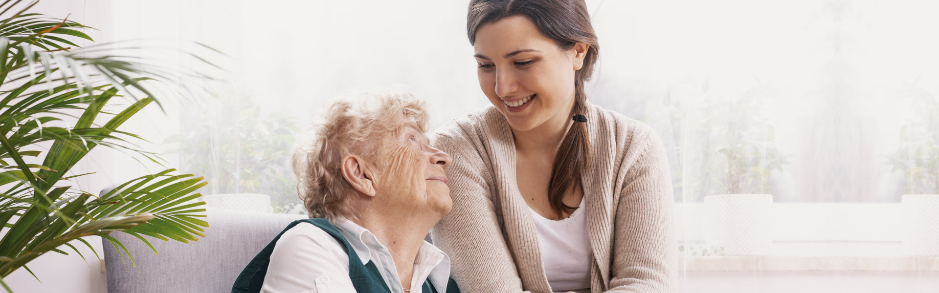 elderly woman looking at the smiling lady