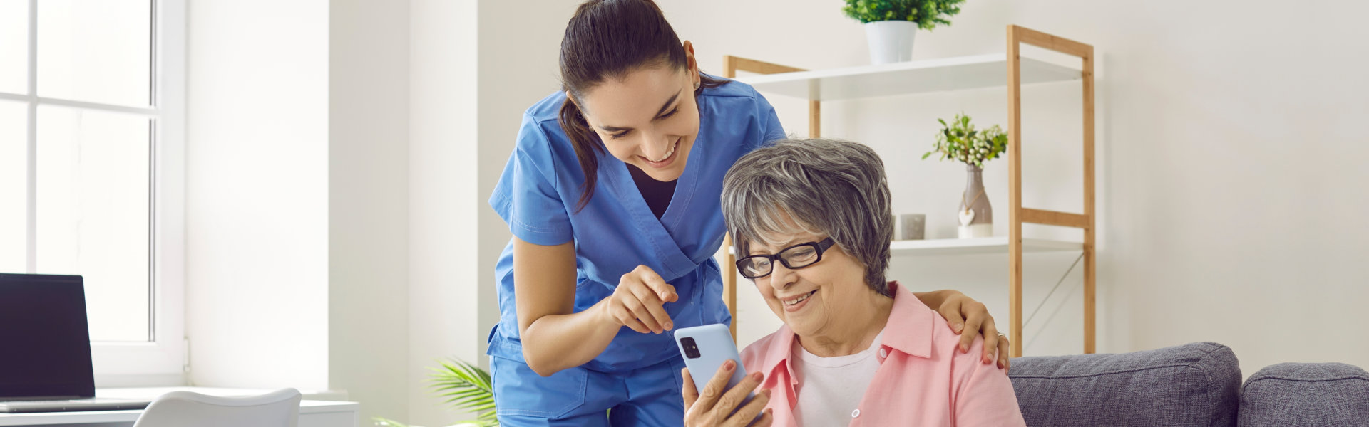 lady and elderly looking at the phone