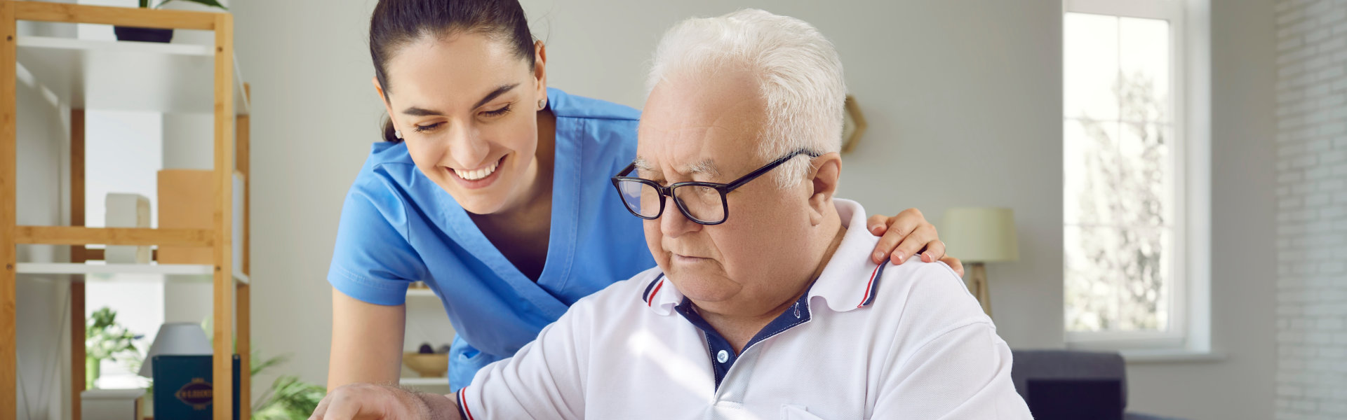 aide and elderly man playing puzzle