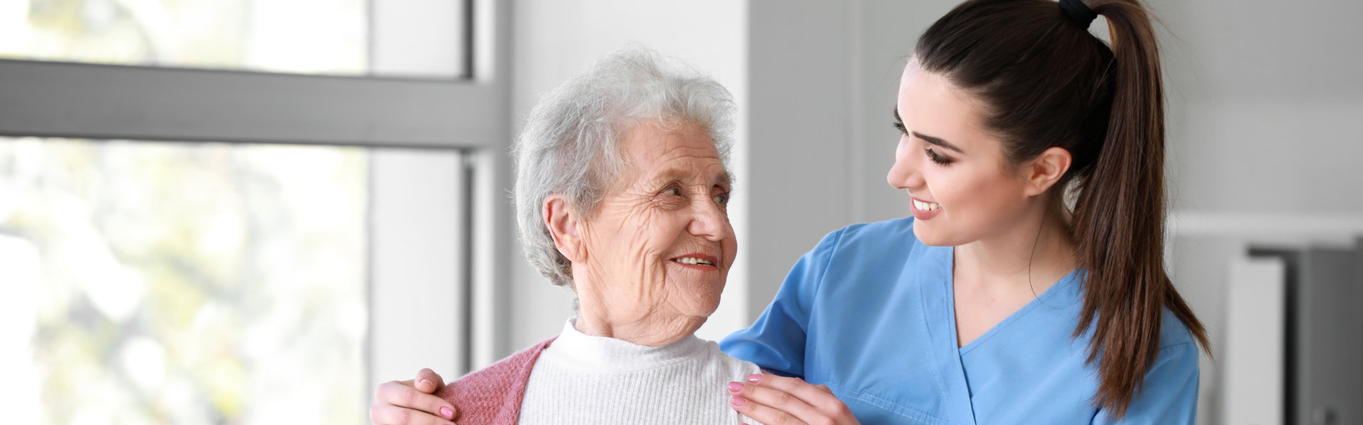 Lady holding the elderly shoulders