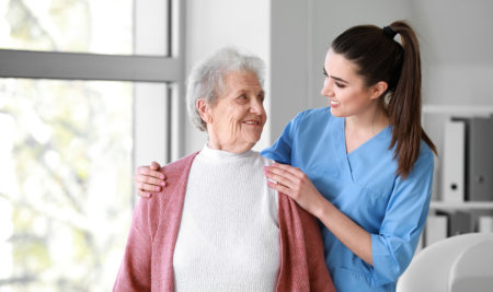 lady holding the shoulders of the elderly